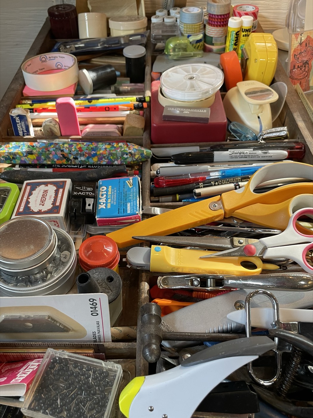 A drawer of craft tools and supplies in the studio